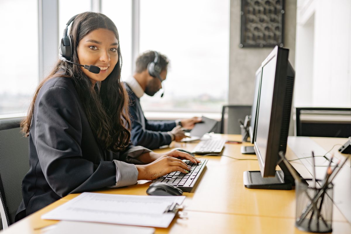 Customer support agent with a headset handling a live call
